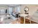 Open-concept living space featuring hardwood floors, a comfortable gray sofa, and a dining area near a window at 4344 Chase St, Denver, CO 80212