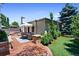 Beautiful backyard patio with outdoor seating, well manicured landscaping, and a stone chimney at 1164 S High St, Denver, CO 80210