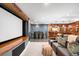 Finished basement with a media area, bar, and a table with chairs at 1164 S High St, Denver, CO 80210