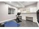 Basement with tile floors, exercise equipment, and a large work area with storage at 1164 S High St, Denver, CO 80210