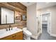 Rustic bathroom featuring wood accent wall, glass enclosed shower, and modern fixtures at 1164 S High St, Denver, CO 80210