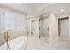 Beautiful bathroom with a glass shower, soaking tub, and marble tile at 1164 S High St, Denver, CO 80210