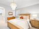 Bright bedroom with a wooden bed frame, chandelier, and decorative mirror at 1164 S High St, Denver, CO 80210
