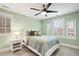 Cozy bedroom with a ceiling fan, light green walls, and bright windows at 1164 S High St, Denver, CO 80210