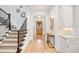 Bright foyer with hardwood floors, an elegant staircase, and a decorative console table at 1164 S High St, Denver, CO 80210
