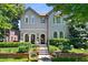 Stunning home with a landscaped front yard, arched entry, stone details, and a welcoming front door at 1164 S High St, Denver, CO 80210