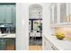 Stylish kitchen hallway with light blue cabinets, dark backsplash, and white countertop at 1164 S High St, Denver, CO 80210
