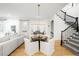 Bright and airy living room with staircase, dining area, and window bench at 1164 S High St, Denver, CO 80210