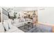Open concept: living room flows to modern kitchen, showcasing stairs, and stylish design at 1164 S High St, Denver, CO 80210