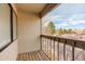 Private balcony with wooden flooring and a view of the surrounding trees and blue sky at 3525 28Th St # 304, Boulder, CO 80301