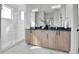 Modern bathroom with double vanity, sleek fixtures, and a glass-enclosed shower with white tiles at 5920 W 91St Ave, Westminster, CO 80031