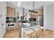 Modern kitchen featuring wood cabinetry, stainless steel appliances, and an island with seating at 5920 W 91St Ave, Westminster, CO 80031