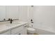 Bathroom with white tub, quartz countertop, and dark fixtures provides modern appeal at 42958 Colonial Trl, Elizabeth, CO 80107