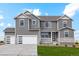 Charming gray two-story home with a three-car garage and manicured lawn at 42958 Colonial Trl, Elizabeth, CO 80107