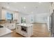 Bright, modern kitchen features an island, white cabinetry, and stainless steel appliances at 42958 Colonial Trl, Elizabeth, CO 80107