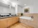 Bright bathroom featuring double sinks, a soaking tub, and modern decor at 1449 Wynkoop St # 305, Denver, CO 80202