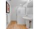 Modern bathroom features tiled shower, pedestal sink, and neutral paint at 1449 Wynkoop St # 305, Denver, CO 80202