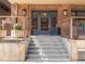 Building entrance featuring brick facade, glass door with visible signage, and concrete steps at 1449 Wynkoop St # 305, Denver, CO 80202