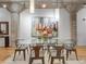 Bright dining room with a glass table, modern chairs, hardwood floors and an art wall at 1449 Wynkoop St # 305, Denver, CO 80202