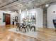 Open dining area with a glass dining table and industrial modern finishes at 1449 Wynkoop St # 305, Denver, CO 80202