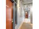 Hallway with apartment door, concrete ceiling, and visible hallway lighting fixtures at 1449 Wynkoop St # 305, Denver, CO 80202