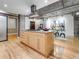 Open kitchen featuring a center island, stainless steel range hood and hardwood floors at 1449 Wynkoop St # 305, Denver, CO 80202