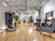 Spacious living room with hardwood floors, exposed concrete ceilings, and lots of natural light at 1449 Wynkoop St # 305, Denver, CO 80202
