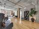 Spacious living room featuring an open floor plan with brick wall and hardwood floors at 1449 Wynkoop St # 305, Denver, CO 80202