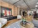 Open-concept living room featuring built-in shelving, modern furnishings, and exposed concrete ceilings at 1449 Wynkoop St # 305, Denver, CO 80202