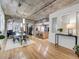 Open floor plan showcasing the dining area, living room, and kitchen with concrete ceilings and wooden floors at 1449 Wynkoop St # 305, Denver, CO 80202