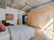 Comfortable main bedroom featuring a large wardrobe, modern décor and exposed concrete ceilings at 1449 Wynkoop St # 305, Denver, CO 80202