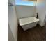 Modern bathroom showcasing a stylish freestanding soaking tub and wood look floors at 59440 E 56Th Ave, Strasburg, CO 80136