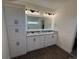 Spacious primary bathroom boasts double sinks, granite countertop, and stylish cabinetry at 59440 E 56Th Ave, Strasburg, CO 80136