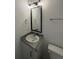 Bathroom with modern vanity featuring granite countertop and stylish mirror with a window for natural light at 59440 E 56Th Ave, Strasburg, CO 80136