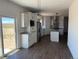 This spacious kitchen offers stainless steel appliances, a large island, and sliding glass door access to the backyard at 59440 E 56Th Ave, Strasburg, CO 80136