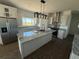 Modern kitchen with granite countertops, stainless steel appliances, and stylish island at 59440 E 56Th Ave, Strasburg, CO 80136