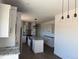Contemporary kitchen with granite island, stainless steel appliances, modern lighting, and custom cabinetry at 59440 E 56Th Ave, Strasburg, CO 80136
