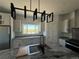 Bright kitchen featuring granite countertops, a stainless steel refrigerator and black pendant lights at 59440 E 56Th Ave, Strasburg, CO 80136