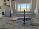 Kitchen featuring granite countertops, stainless appliances, shaker cabinets and a large island with a sink at 59440 E 56Th Ave, Strasburg, CO 80136
