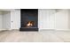 Finished basement features a cozy fireplace with new flooring and neutral paint at 3483 S Race St, Englewood, CO 80113