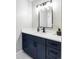 Bathroom showcasing a navy blue single sink vanity with black hardware at 3483 S Race St, Englewood, CO 80113