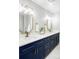Bathroom showcasing double sink vanity with navy blue cabinets and gold fixtures at 3483 S Race St, Englewood, CO 80113