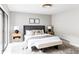 Modern bedroom with a large window, rug, and a bench at the end of the bed at 3483 S Race St, Englewood, CO 80113