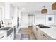 Bright modern kitchen with stainless steel appliances, a breakfast bar, and stylish light fixtures at 3483 S Race St, Englewood, CO 80113