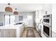Bright kitchen with quartz counters, stainless appliances, and modern lighting at 3483 S Race St, Englewood, CO 80113