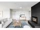 Bright, spacious living room featuring a cozy fireplace, natural light, and stylish decor at 3483 S Race St, Englewood, CO 80113