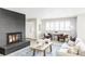 Comfortable living room featuring a fireplace, ample seating, and plantation shutters at 3483 S Race St, Englewood, CO 80113