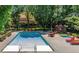 Community pool with red deck chairs and mature trees at 3483 S Race St, Englewood, CO 80113