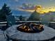 Inviting fire pit with seating under a dramatic sunset sky, perfect for outdoor gatherings at 20249 Terrace View Dr, Parker, CO 80134