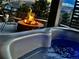 Relax in the hot tub with the cozy ambiance of the nearby fire pit at 20249 Terrace View Dr, Parker, CO 80134